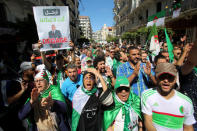 FILE PHOTO: A demonstrator holds a banner depicting Algeria's interim president Abdelkader Bensalah during a protest demanding the removal of Algeria's ruling elite in Algiers, Algeria May 10, 2019. The banner reads: "Leave, you don't represent us". REUTERS/Ramzi Boudina/File Photo