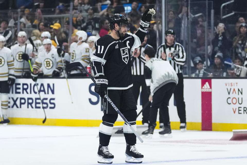 Los Angeles Kings center Anze Kopitar (11) reacts as he is recognized for breaking the team's record for number of games played during the first period of an NHL hockey game against the Boston Bruins Saturday, Oct. 21, 2023, in Los Angeles. (AP Photo/Ashley Landis)