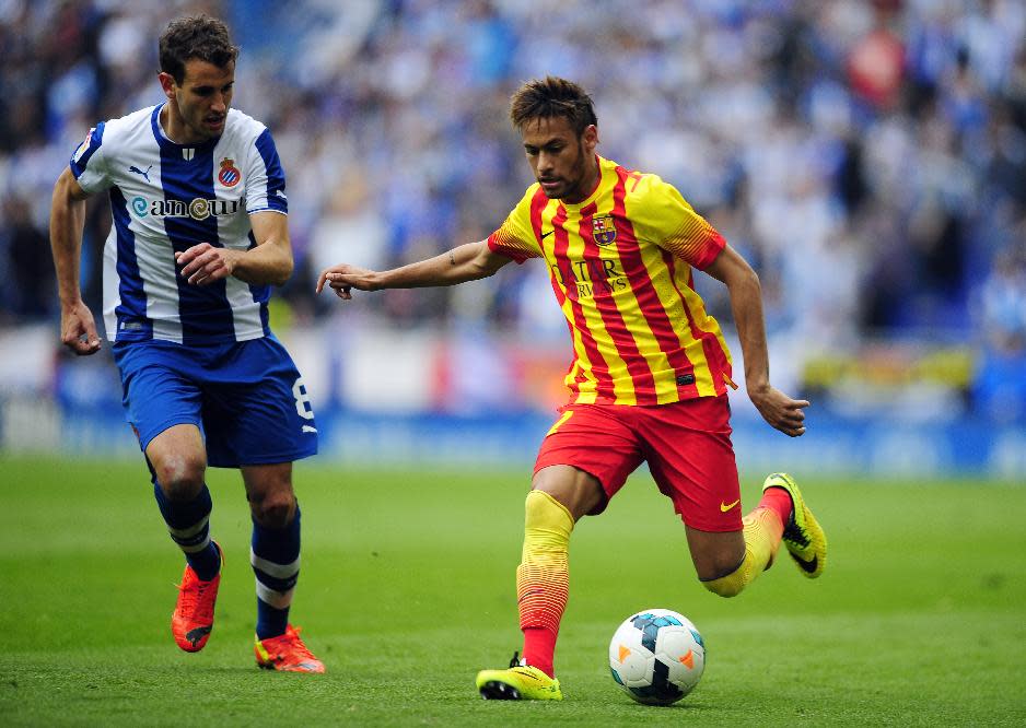 FC Barcelona's Neymar, from Brazil, right, duels for the ball against Espanyol's Christian Stuani during a Spanish La Liga soccer match at Cornella-El Prat stadium in Cornella Llobregat, Spain, Saturday, March 29, 2014. (AP Photo/Manu Fernandez)