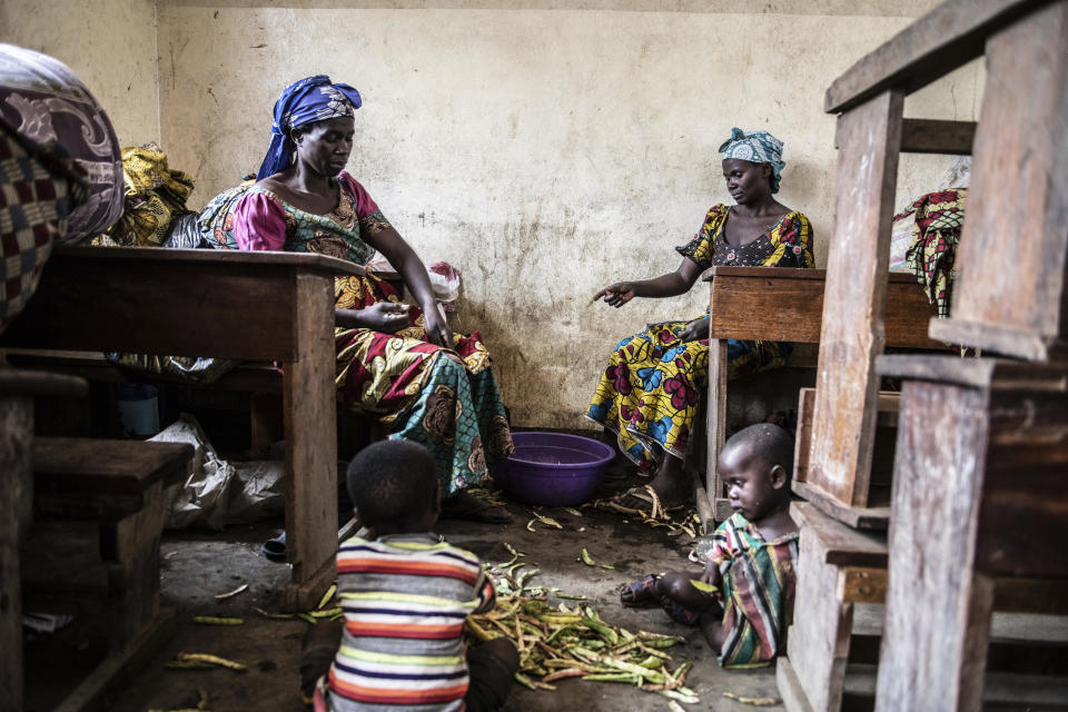 People fleeing the fighting between M23 forces and Congolese army find refuge in a church in Kibumba, north of Goma, Democratic Republic of Congo, Friday Jan. 28, 2022. In the past week, inhabitants from six villages in the country's east – including, Bukima, Nyesisi, and Ruhanga – have fled the violence. At least 2,000 people are now living in improvised shelters, in churches, schools or with host families. (AP Photo/Moses Sawasawa)