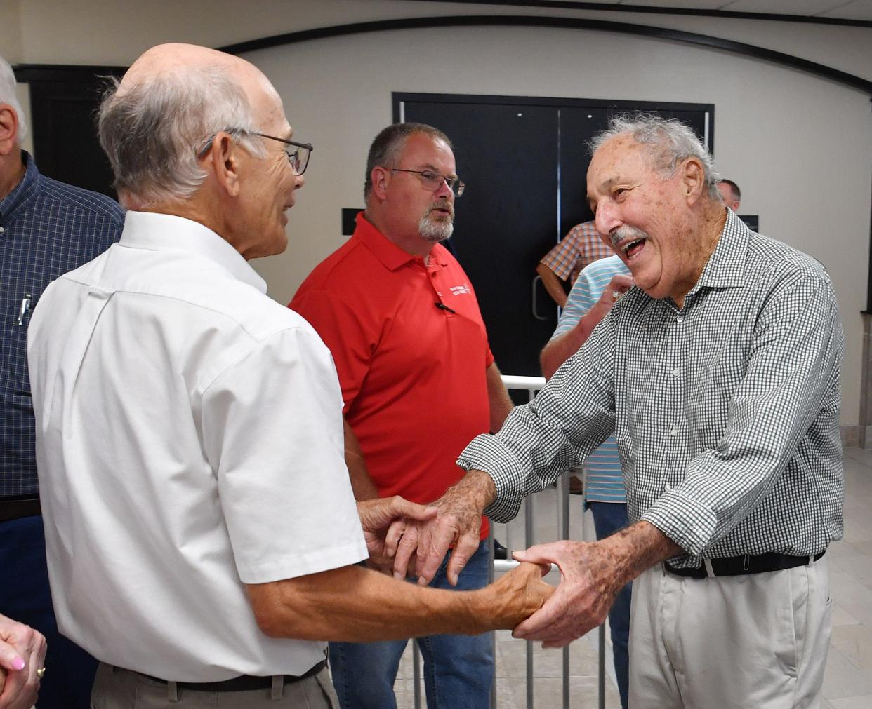 Former Wichita County Judge Nick Gipson, left, congratulates Willie Wall on his retirement after 40 years as administrative assistant to county judges.