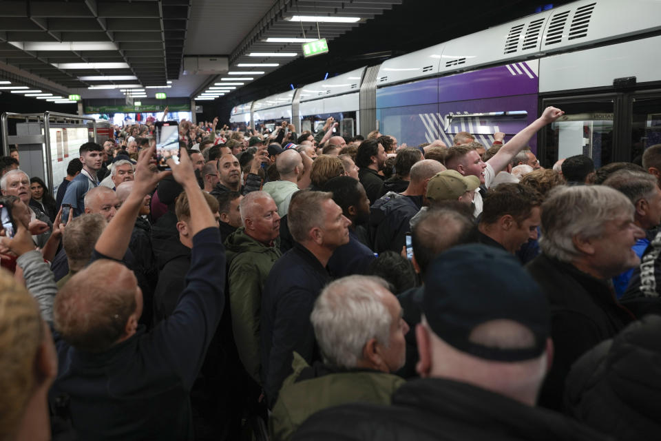 Soccer fans gather on train station ahead the Group C match between Serbia and England at the Euro 2024 soccer tournament in Gelsenkirchen, Germany, Sunday, June 16, 2024. (AP Photo/Markus Schreiber)