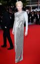High shine style! Tilda arrives to <em>The Dead Don't Die</em> premiere in a silver sequin long-sleeve column gown with Cartier bracelet and ring.