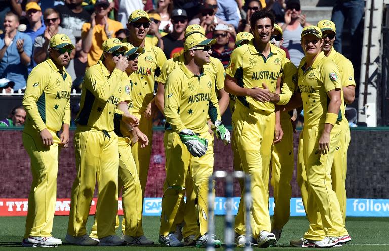 Australia's paceman Mitchell Starc (2-R) celebrates his first wicket of New Zealand's Brendon McCullum with teammates during the World Cup final between Australia and New Zealand in Melbourne on March 29, 2015