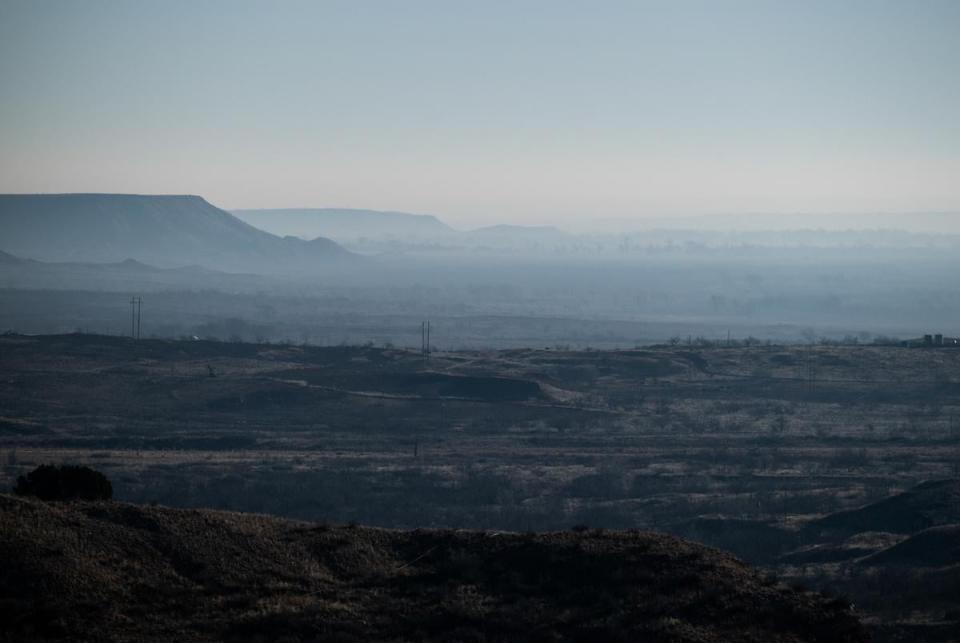 Smoke hangs in the Canadian River Valley south of Stinnett, Texas after multiple days of wild fires Friday, March. 1, 2024.