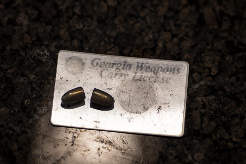 Janet Paulsen applied for a concealed carry permit hours before she was shot by her estranged husband at their home in Acworth, Ga., in 2015. It arrived 10 days later, after doctors had removed these bullets from her body. She displayed the items at her home on Monday, Aug. 7, 2023. (AP Photo/David Goldman)