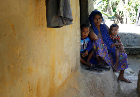 A Rohingya woman and her children look on as they sit in front of their house at Kutupalang Refugee Camp in Cox’s Bazar, Bangladesh, November 21, 2016. REUTERS/Mohammad Ponir Hossain