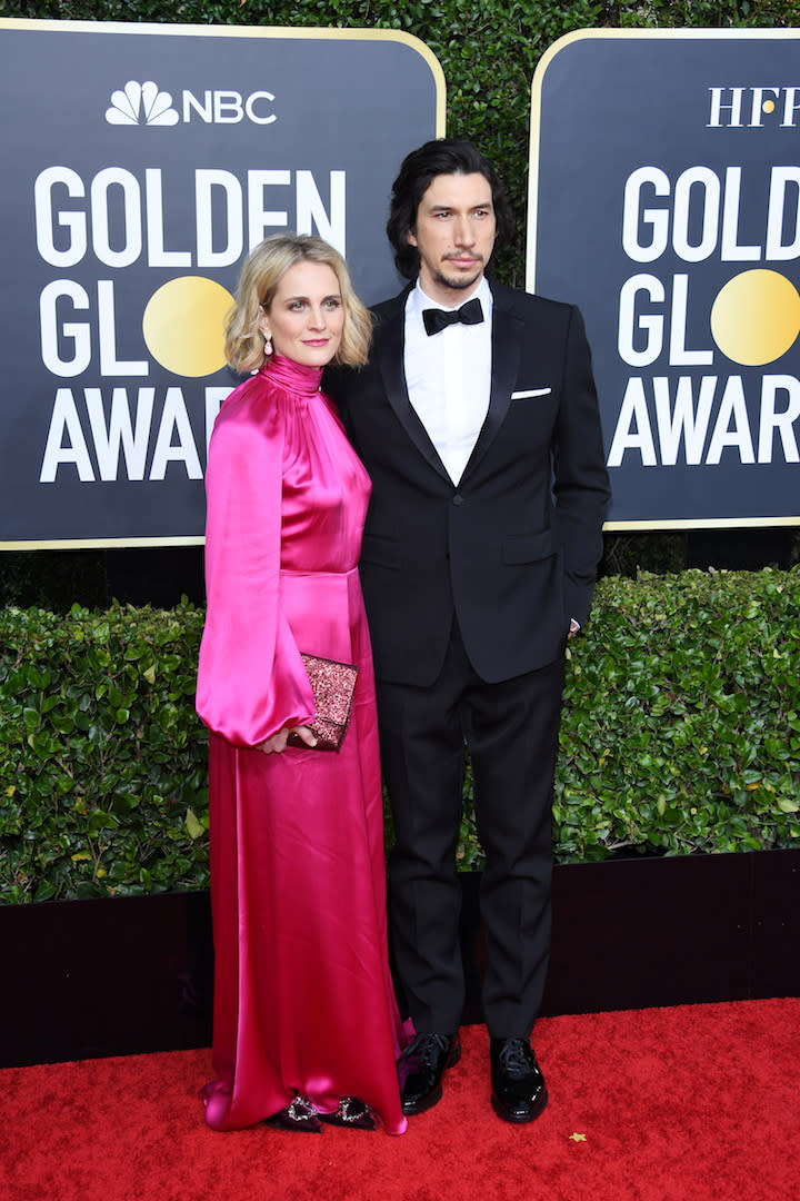 Joanne Tucker is wearing a fuschia-hued satin dress while Adam Driver opted for a tuxedo. <em>[Photo: Getty]</em>