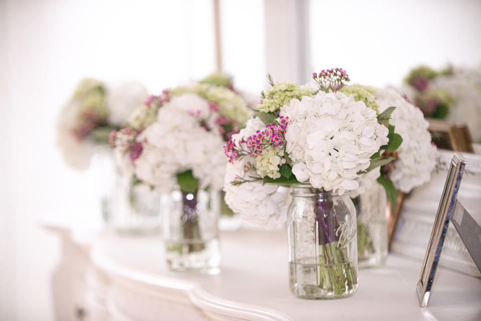 Mason jars with florals at a wedding