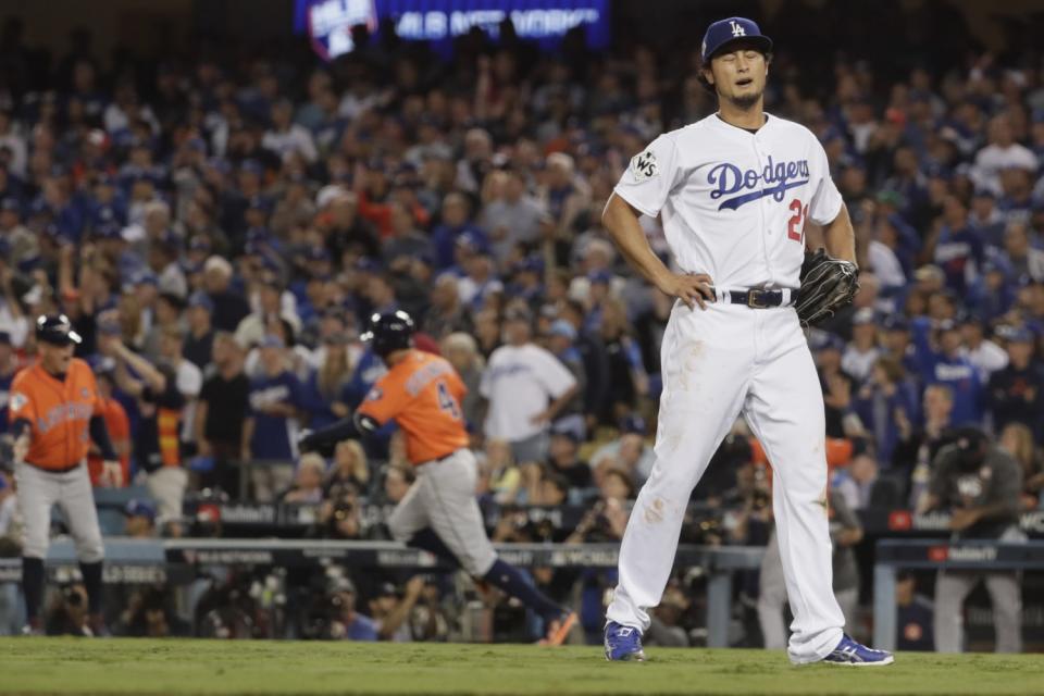 Yu Darvish recoils as the Houston Astros score on a two-run home run by George Springer.