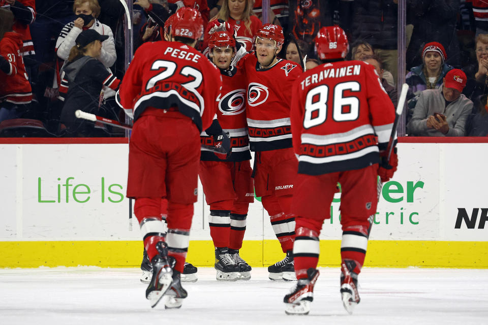 Carolina Hurricanes' Paul Stastny, second from right, celebrates after his goal with teammates Seth Jarvis, second from left, Brett Pesce (22) and Teuvo Teravainen (86) during the first period of an NHL hockey game against the Nashville Predators in Raleigh, N.C., Thursday, Jan. 5, 2023. (AP Photo/Karl B DeBlaker)
