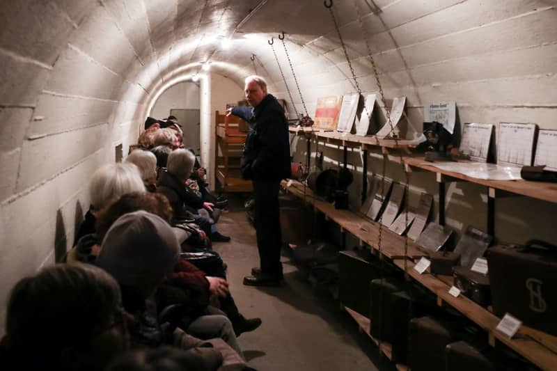 Gunnar Wulf, head of the district archive in Hamburg-Hamm, speaks to a group of visitors to the Hamburg Bunker Museum. The tubular bunker from the Second World War has been a museum since 1997. Christian Charisius/dpa