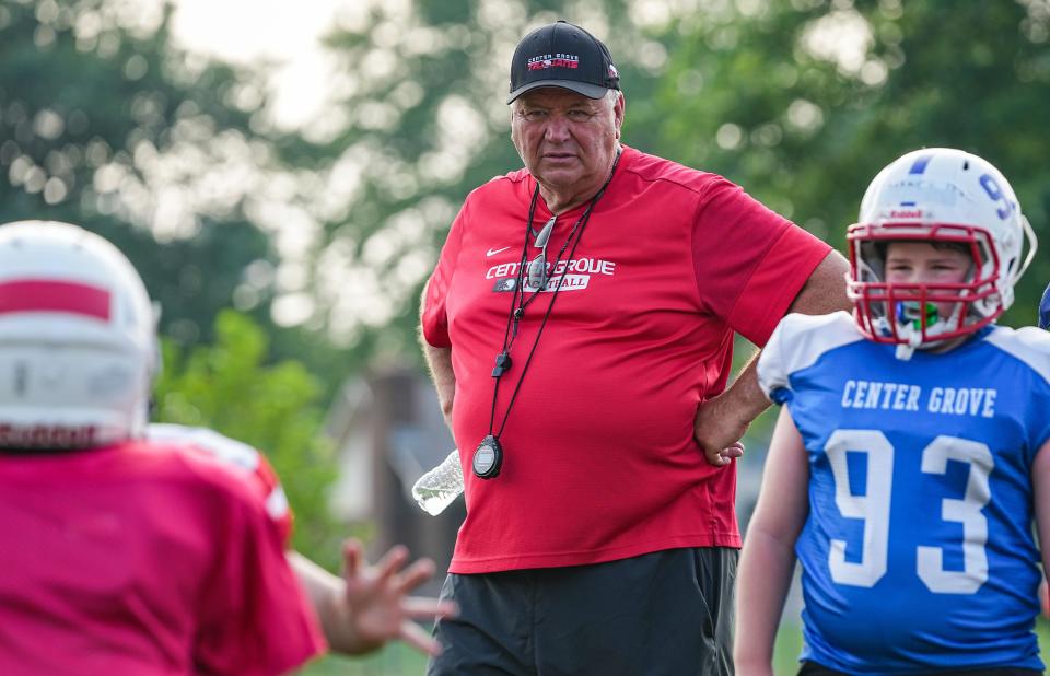 Center Grove head coach Eric Moore watches youth players run drills Tuesday, July 18, 2023, during practice at annual skills football camp in Bagersville.