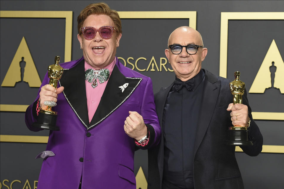 Elton John, left, and Bernie Taupin, winners of the award for best original song for "(I'm Gonna) Love Me Again" from "Rocketman", pose in the press room at the Oscars on Sunday, Feb. 9, 2020, at the Dolby Theatre in Los Angeles. (Photo by Jordan Strauss/Invision/AP)