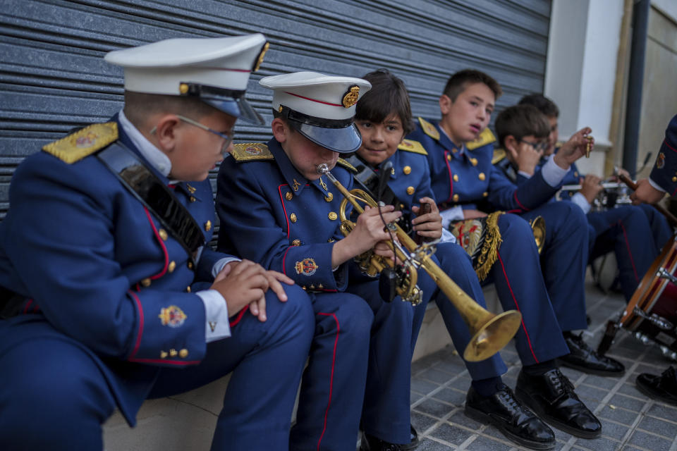 Members of the band practice prior to the procession at the Veracruz church in Aguilar de la Frontera, southern Spain, Tuesday, April 4, 2023. Hundreds of processions take place throughout Spain during the Easter Holy Week. (AP Photo/Manu Fernandez)