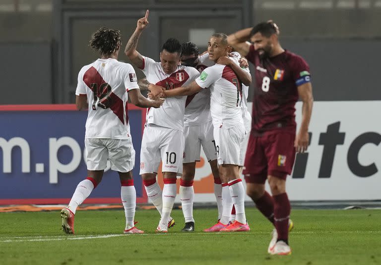 Christian Cueva (centro) festeja tras marcar el gol de Perú en la victoria 1-0 ante Venezuela en el partido por las eliminatorias del Mundial, el domingo 5 de septiembre de 2021, en Lima. (AP Foto/Martín Mejía, Pool)