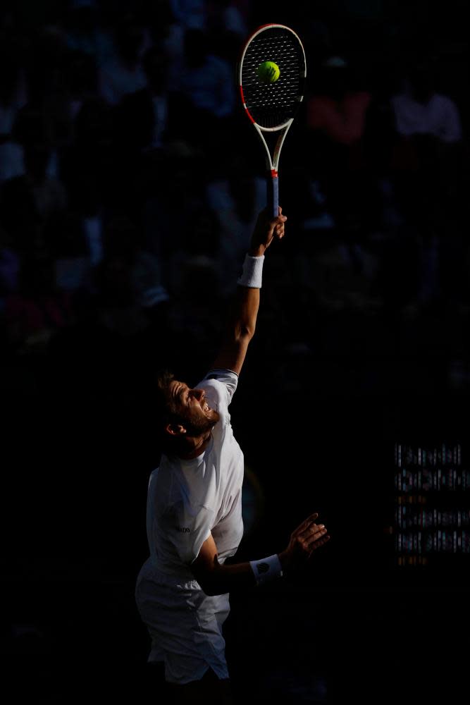 Cameron Norrie fires off a serve to David Goffin.