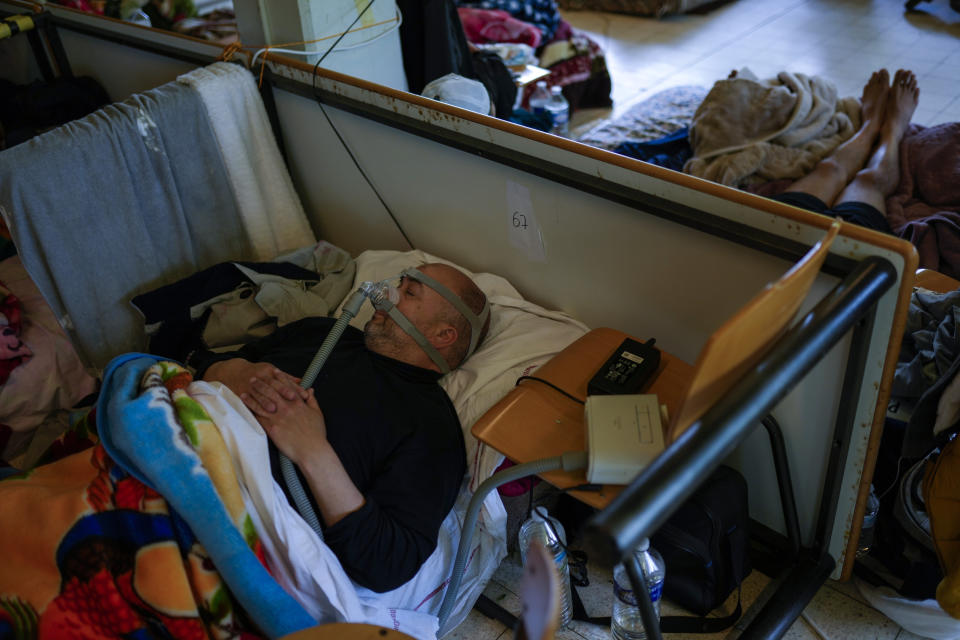 A man on hunger strike rests as he occupies with others a big room of the ULB Francophone university in Brussels, Tuesday, June 29, 2021. More than two hundreds of migrants without official papers and who have been occupying a church and two buildings of two Brussels universities since last February, began a hunger strike on 23 May to draw the attention of Brussels authorities to their plight. (AP Photo/Francisco Seco)