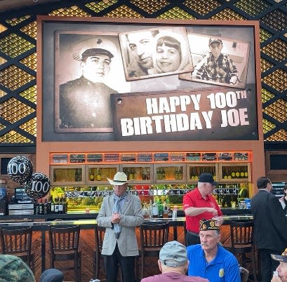 Large screen television with images of young Joe DeMarco who celebrated his 100th birthday at Parx Casino in Bensalem.