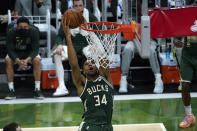 Milwaukee Bucks forward Giannis Antetokounmpo (34) dunks against the Phoenix Suns during the second half of Game 3 of basketball's NBA Finals in Milwaukee, Sunday, July 11, 2021. (AP Photo/Paul Sancya)