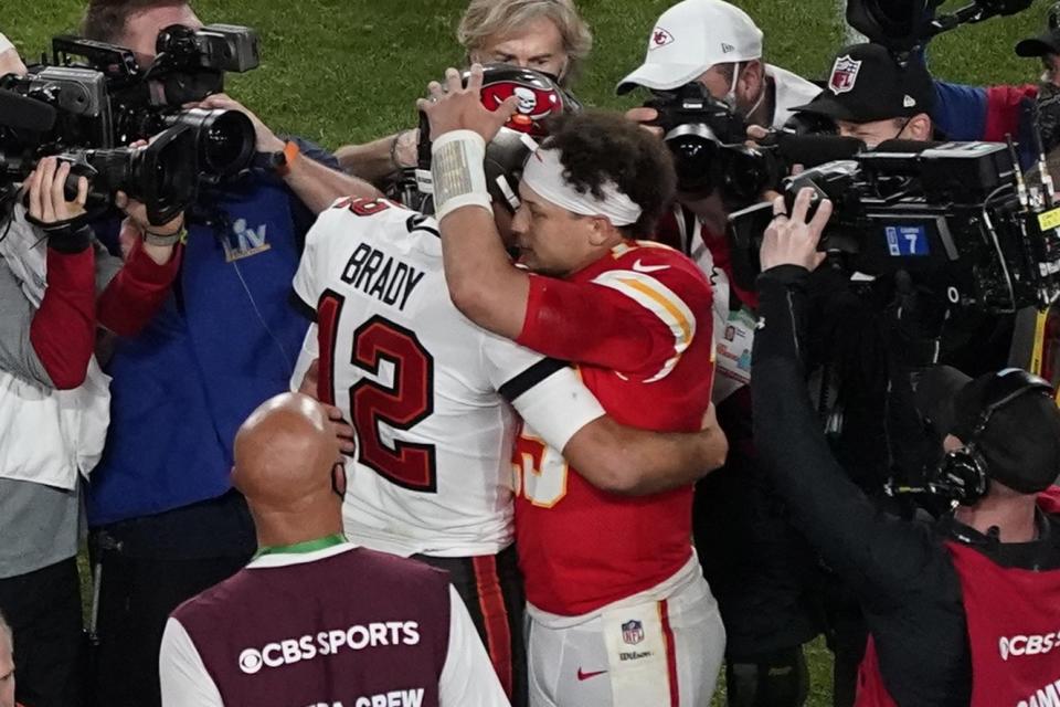 Tampa Bay Buccaneers' Tom Brady (12) and Kansas City Chiefs' Patrick Mahomes (15) greet following Super Bowl LV.