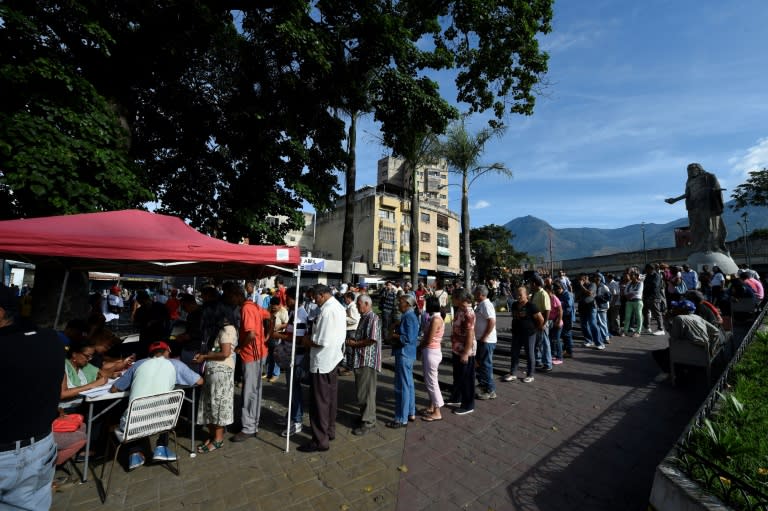 After voting in the election, people are registered under the red canopies in the hopes they will receive prizes promised by President Nicolas Maduro