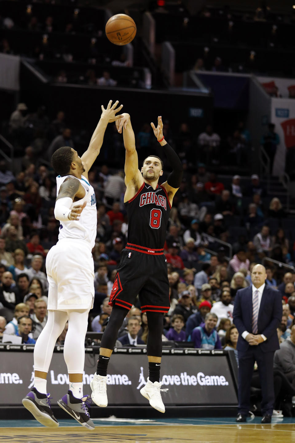 Chicago Bulls' Zach LaVine (8) throws a three-point basket over Charlotte Hornets' Miles Bridges (0) during the second half of an NBA basketball game in Charlotte, N.C., Saturday, Nov. 23, 2019. (AP Photo/Bob Leverone)