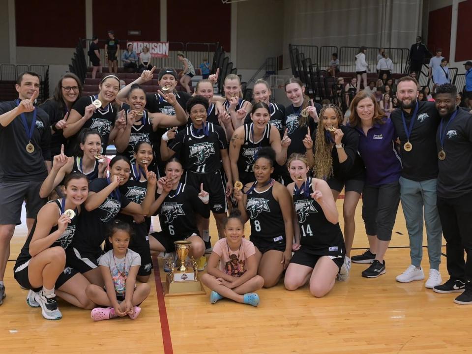 The Halifax Hornets — and a couple of the players' kids — celebrate their championship after a win over the Halifax Thunder. (David Gallant - image credit)