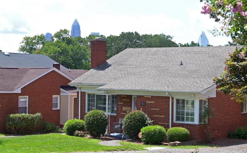 The Charlotte skyline peeks over the canopy behind homes along Patton Avenue in the McCrorey Heights neighborhood. The neighborhood was started by Johnson C. Smith University president Rev. H.L. McCrorey in 1912. JEFF SINER/jsiner@charlotteobserver.com