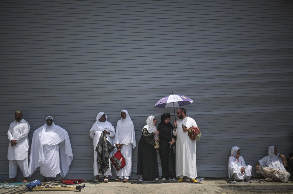 FILE - In this Sept. 18, 2015 file photo, Muslim pilgrims shelter themselves from the heat as they attend Friday afternoon prayers outside the Grand Mosque in the holy city of Mecca, Saudi Arabia. A new study released Monday, May 4, 2020, says 2 to 3.5 billion people in 50 years will be living in a climate that historically has proven just too hot to handle. Currently about 20 million people live in places with an annual average temperature greater than 84 degrees (29 degrees Celsius) — far beyond the temperature sweet spot. That area is less than 1% of the Earth’s land, and it is mostly near the Sahara Desert and includes Mecca, Saudi Arabia. (AP Photo/Mosa'ab Elshamy, File)