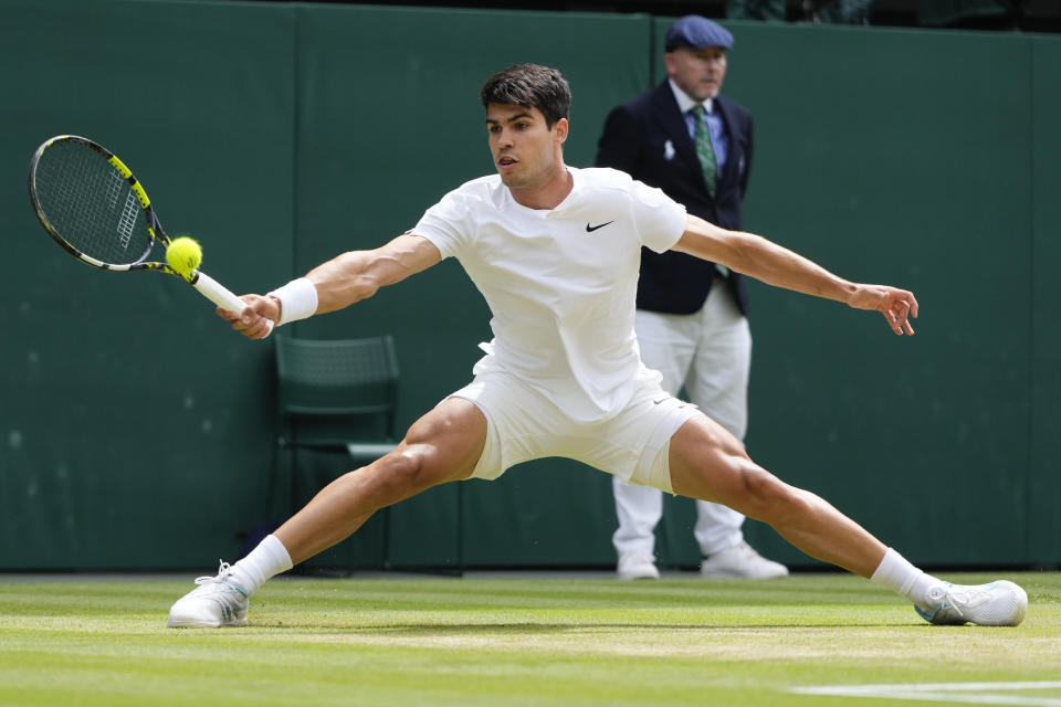 Carlos Alcaraz of Spain plays a forehand return to Daniil Medvedev of Russia during their semifinal match at the Wimbledon tennis championships in London, Friday, July 12, 2024. (AP Photo/Kirsty Wigglesworth)