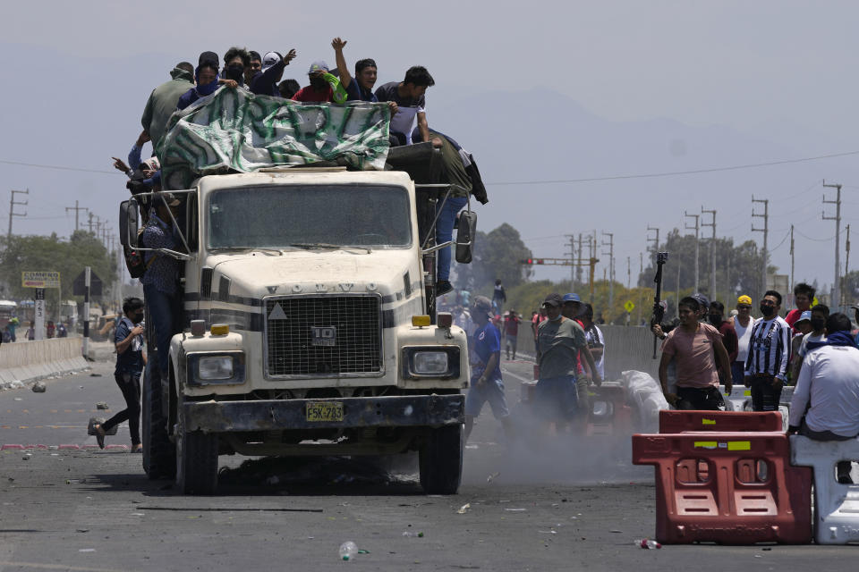 Supporters of ousted Peruvian President Pedro Castillo arrive in a truck to help block the Pan-American South Highway to protest his detention in Ica, Peru, Tuesday, Dec. 13, 2022. Castillo said Tuesday he is being "unjustly and arbitrarily detained" and thanked his supporters for their "effort and fight" since he was taken into custody on Dec. 7. (AP Photo/Martin Mejia)