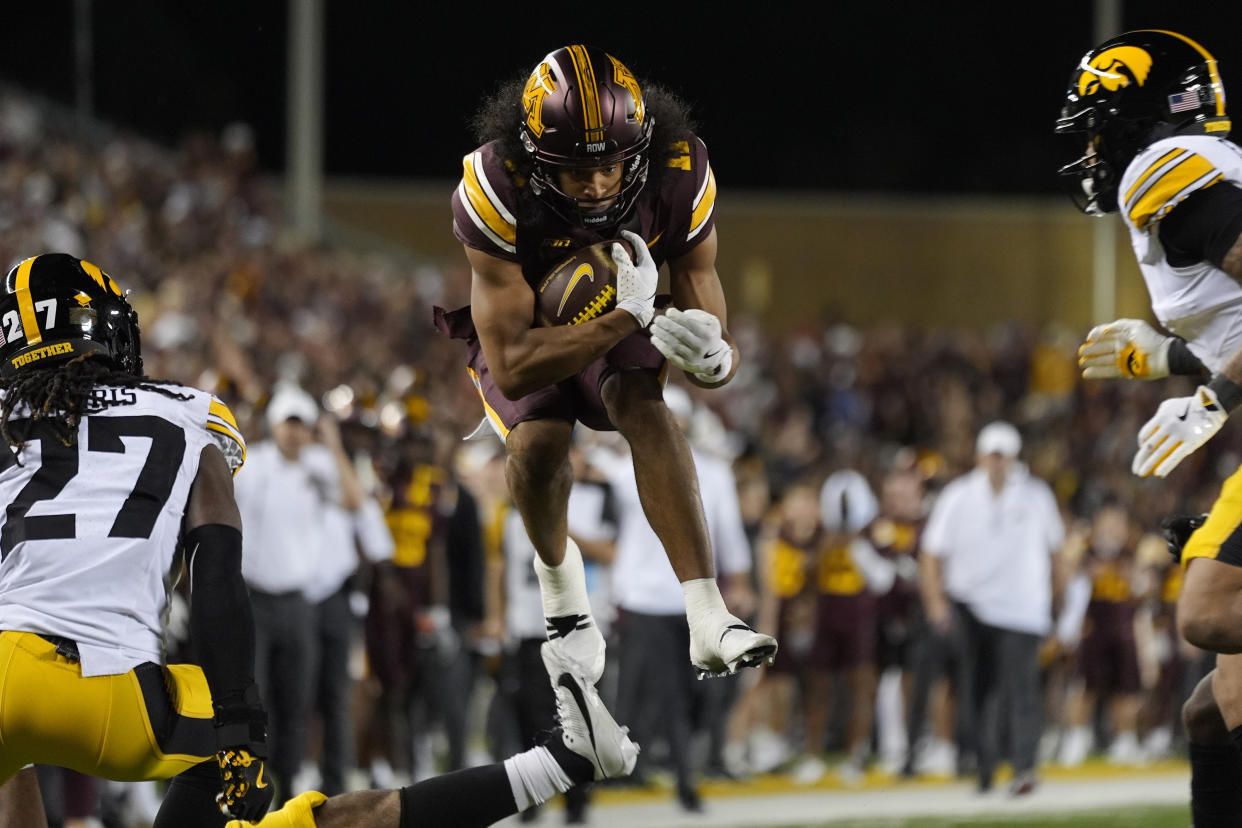 Minnesota wide receiver Elijah Spencer (11) leaps to score an 11-yard touchdown during the first half of an NCAA college football game against Iowa, Saturday, Sept. 21, 2024, in Minneapolis. (AP Photo/Abbie Parr)