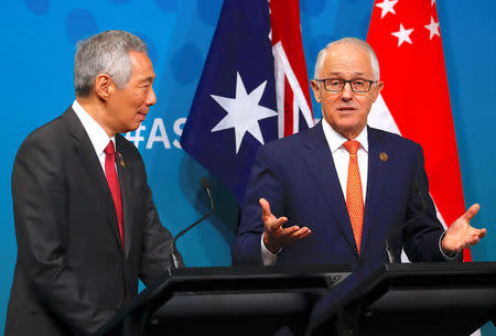 Australian Prime Minister Malcolm Turnbull walks behind Prime Minister of Singapore Lee Hsien Loong talk during their media conference during the one-off summit of 10-member Association of Southeast Asian Nations (ASEAN) in Sydney, Australia, March 16, 2018. REUTERS/David Gray