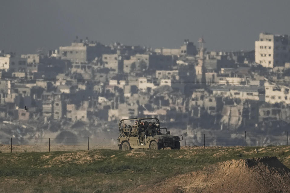 Israeli soldiers are seen along the Israeli-Gaza border, southern Israel, Tuesday, Dec. 19, 2023. (AP Photo/Leo Correa)