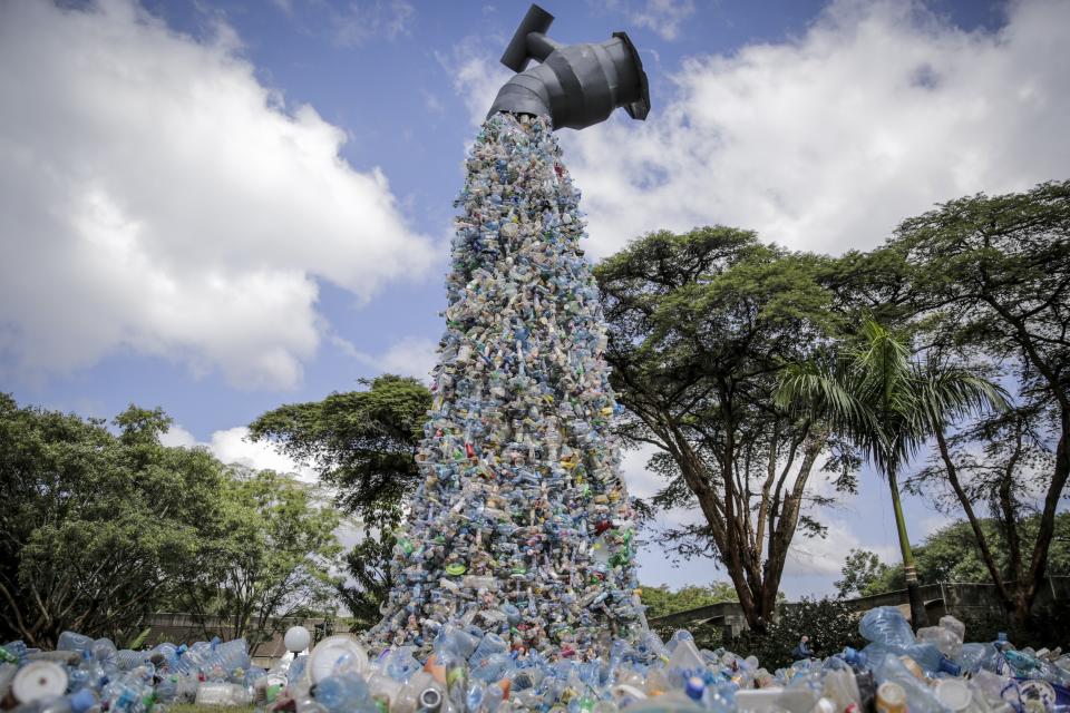 FILE - A giant art sculpture showing a tap outpouring plastic bottles, each of which was picked up in the neighborhood of Kibera, during the U.N. Environment Assembly (UNEA) held at the U.N. Environment Programme (UNEP) headquarters in Nairobi, Kenya, March 2, 2022. (AP Photo/Brian Inganga, File)
