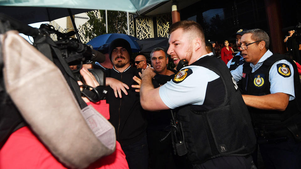 Supporters, members of the media and police officers, pictured here jostling after the sentencing of Jarryd Hayne.