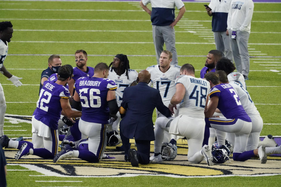 Tennessee Titans and the Minnesota Vikings players meet at midfield following an NFL football game, Sunday, Sept. 27, 2020, in Minneapolis. Tennessee won 31-30. The NFL says the Tennessee Titans and Minnesota Vikings are suspending in-person activities after the Titans had three players test positive for the coronavirus, along with five other personnel. The league says both clubs are working closely with the NFL and the players’ union on tracing contacts, more testing and monitoring developments. The Titans are scheduled to host the Pittsburgh Steelers on Sunday.(AP Photo/Jim Mone)