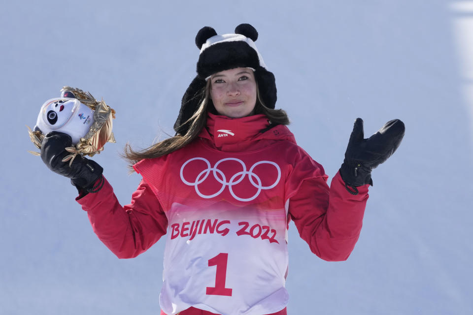 Gold medal winner China's Eileen Gu celebrates during the venue award ceremony for the women's halfpipe at the 2022 Winter Olympics, Friday, Feb. 18, 2022, in Zhangjiakou, China. (AP Photo/Lee Jin-man)