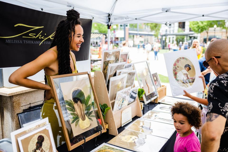 Melissa Tshikamba speaks with customers at her booth during the Juneteenth celebration at The Gateway in Salt Lake City on June 19, 2023. | Ryan Sun, Deseret News