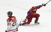 Russia's Eduard Gimatov (R) celebrates his goal as Canada's Anthony Mantha skates by during the first period of their IIHF World Junior Championship ice hockey game in Malmo, Sweden, January 5, 2014. REUTERS/Alexander Demianchuk (SWEDEN - Tags: SPORT ICE HOCKEY)