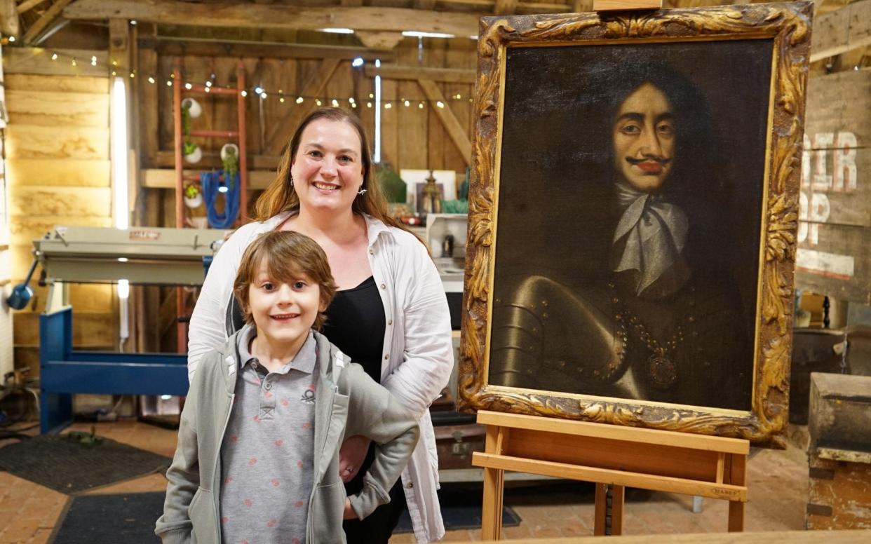Dylan Maggs, then aged seven, and mother Elizabeth Vella with the portrait - BBC