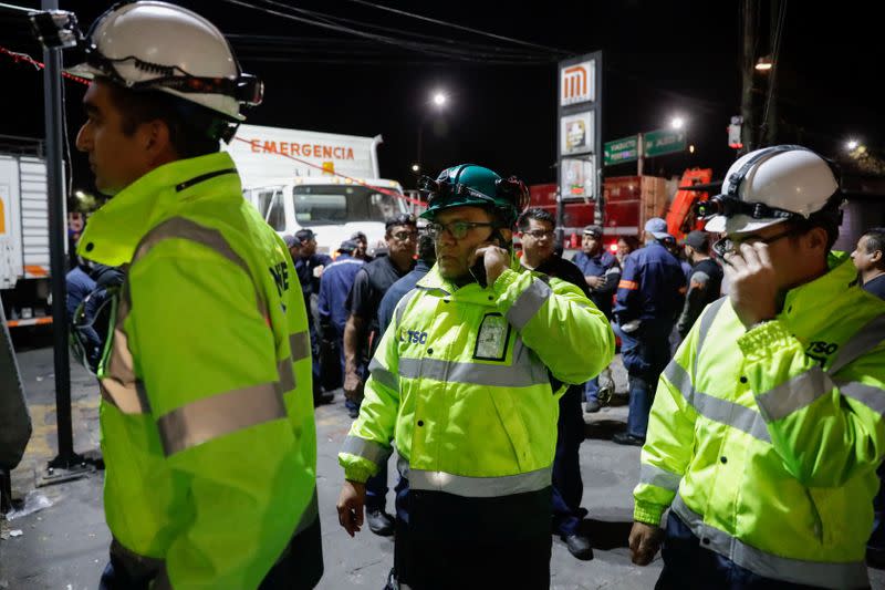 Rescue workers are pictured outside the Tacubaya metro station after several people were injured when two trains collided in the underground metro network, in Mexico City