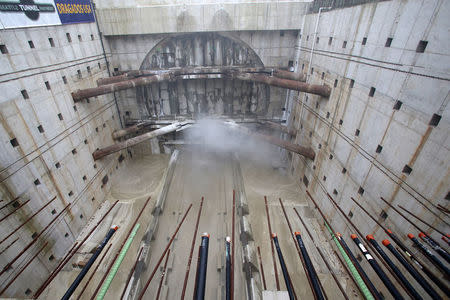 Seattle’s tunnel-drilling machine, Bertha, the world's largest tunnel-boring machine, starts breaking through the concrete wall from the bottom creating massive dust in the disassembly pit in Seattle, Washington, U.S., April 4, 2017. REUTERS/Karen Ducey