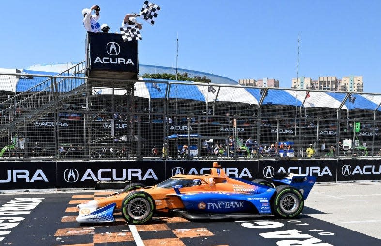 IndyCar driver Scott Dixon takes the checkered flag to win the 49th Acura Grand Prix of Long Beach on Sunday, April 21, 2024.