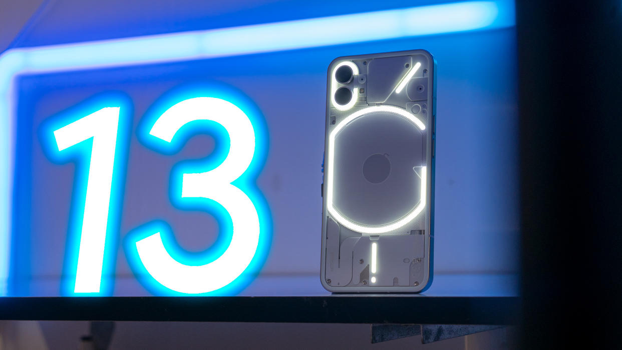  Nothing Phone (1) next to a neon glowing number 13 