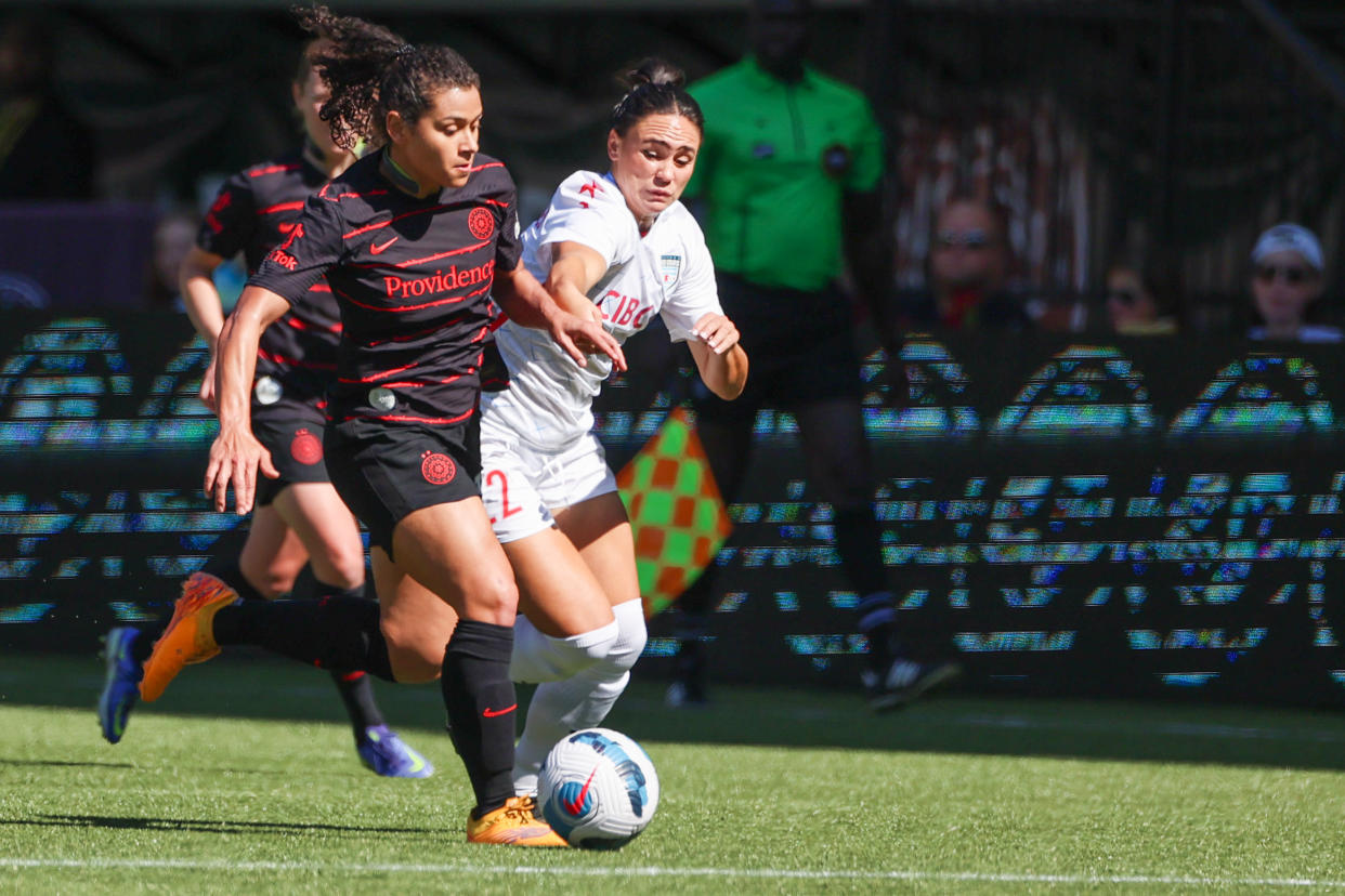Portland Thorns FC midfielder Rocky Rodriguez fights for the ball against Chicago Red Stars defender Bianca St-Georges
