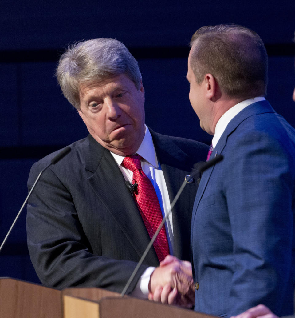Republican gubernatorial candidates State Sen. Frank Wagner, left, shakes the hand of Corey Stewart during a break in their debate at Liberty University in Lynchburg, Va., Thursday, April 13, 2017. (AP Photo/Steve Helber)'