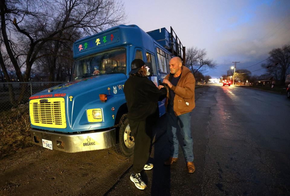 Bear Eagle shakes hands with Steve Cardwell as they celebrate the Nomad Alliance bus making it to a new parking location in West Valley City, on Monday, March 13, 2023. 