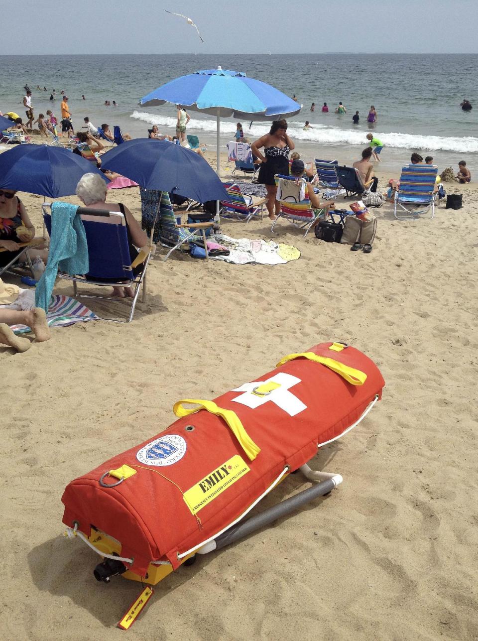 In this Wednesday, Aug, 8, 2012 photo, EMILY, (Emergency Integrated Lifesaving Lanyard) a remote-controlled battery powered lifesaving device, sits on Old Town Beach in Westerly, R.I. EMILY is a small watercraft fitted with a flotation device and can go up to 22 mph, allowing it to get to people more quickly, and in some cases more safely, than any human. (AP Photo/Michelle R. Smith)